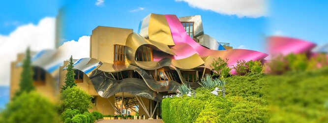 Trip Pauschalreisen Reisetipps - Marqués de Riscal Design Hotel, Bilbao, Elciego, Spanien. Fantastisch galaktisch, unverkennbar ein Werk von Frank O. Gehry. Inmitten idyllischer Weinberge in der Rioja Region des Baskenlandes, bezaubert das schimmernde Bauobjekt mit einer Struktur bunter, edel glänzender verflochtener Metallbänder. Glanz im Baskenland - Es muss etwas ganz Besonderes sein. Emotional, zukunftsweisend, einzigartig. Denn in dieser Region, etwa 133 km südlich von Bilbao, sind Weingüter normalerweise nicht für die Öffentlichkeit zugänglich.